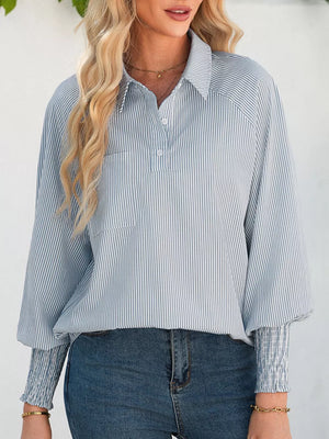 Striped button-up shirt with a collar, chest pocket, and smocked cuffs.