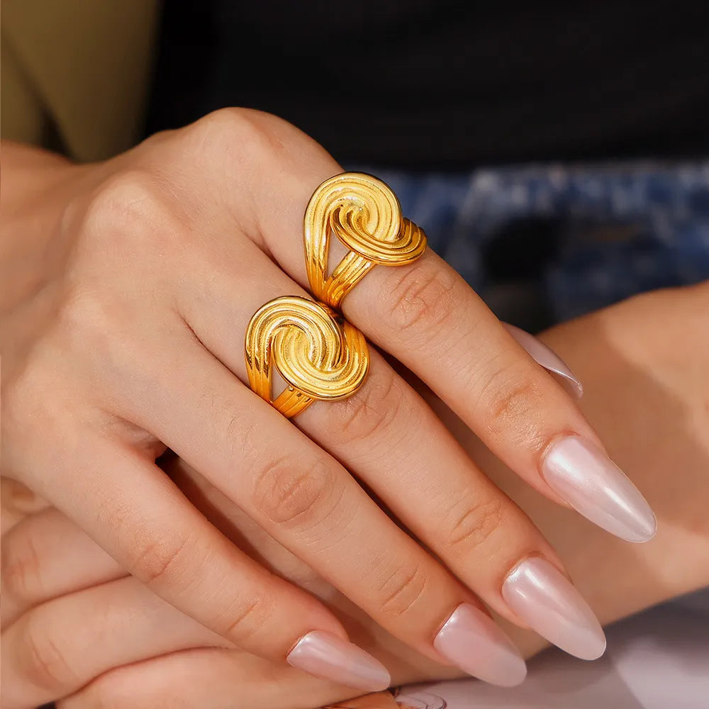 Gold sculptural swirl ring with 18K gold plating.