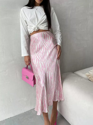 Satin midi skirt with pink and white zebra print, bias cut, and a high waist.