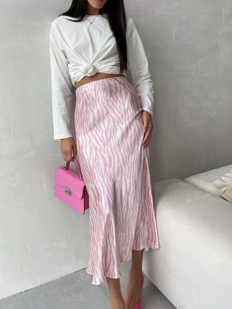 Satin midi skirt with pink and white zebra print, bias cut, and a high waist.