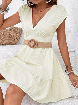 Tiered cap sleeve mini dress in white with a V-neck and ruffled hem.