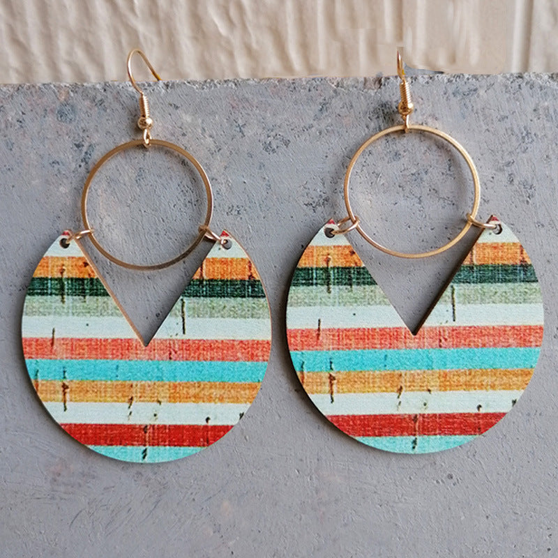 Geometric striped wood drop earrings with gold hoops and a V-cut detail.
