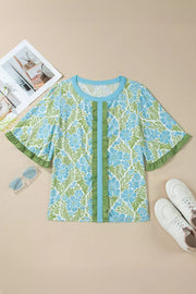 Floral ruffled half sleeve maternity blouse with blue and green floral print and front ruffle detail.