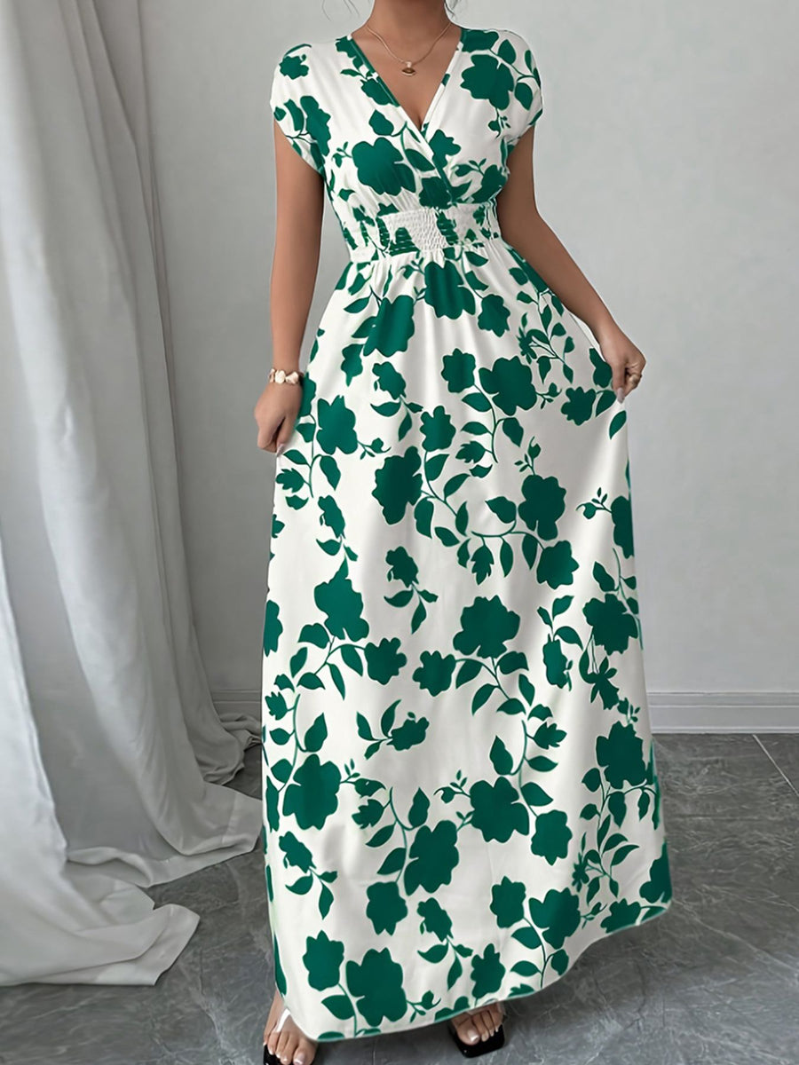 Floral surplice maxi dress in white with green floral print, cap sleeves, and smocked waist.