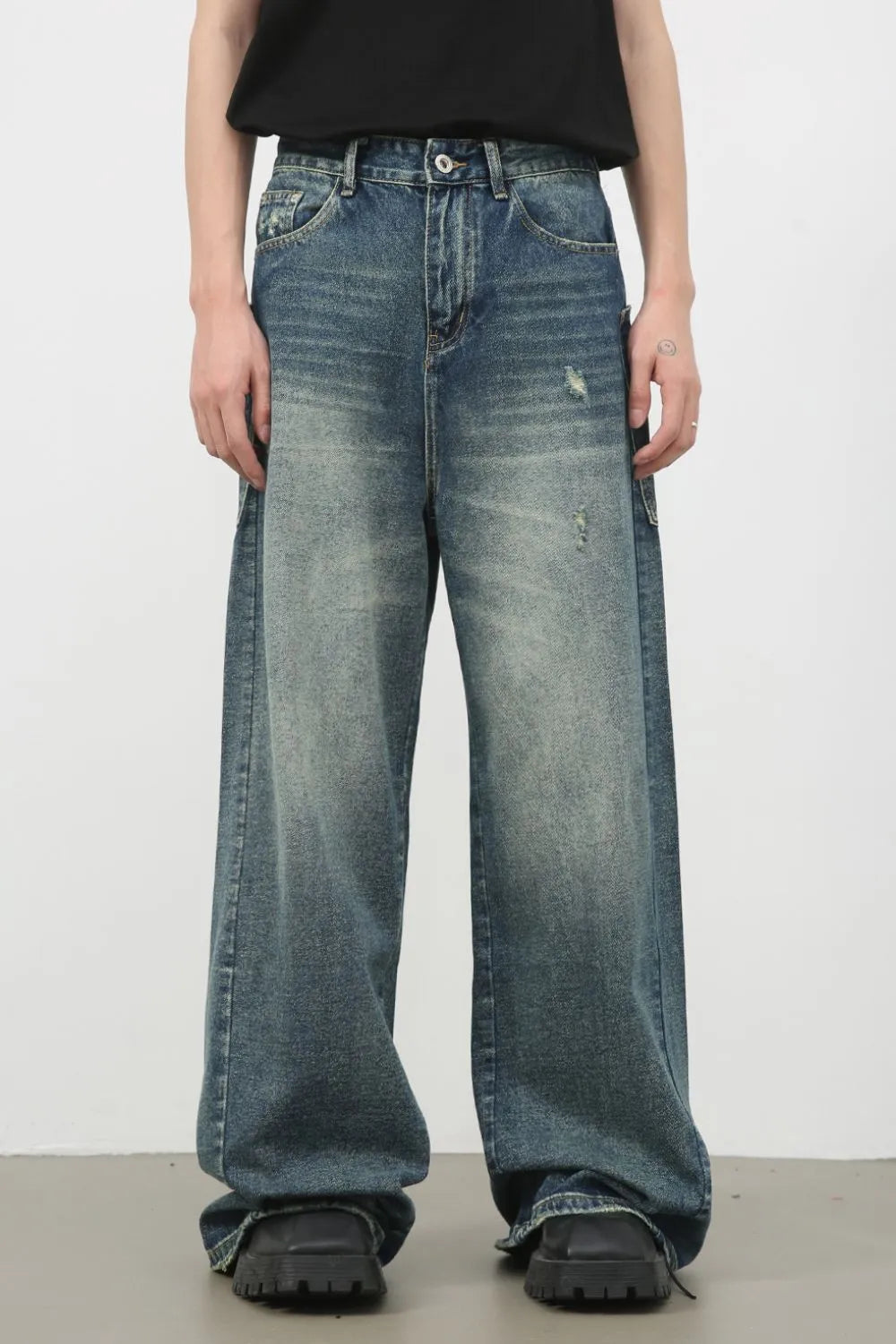 Distressed denim wide leg jeans in medium wash with a relaxed fit.