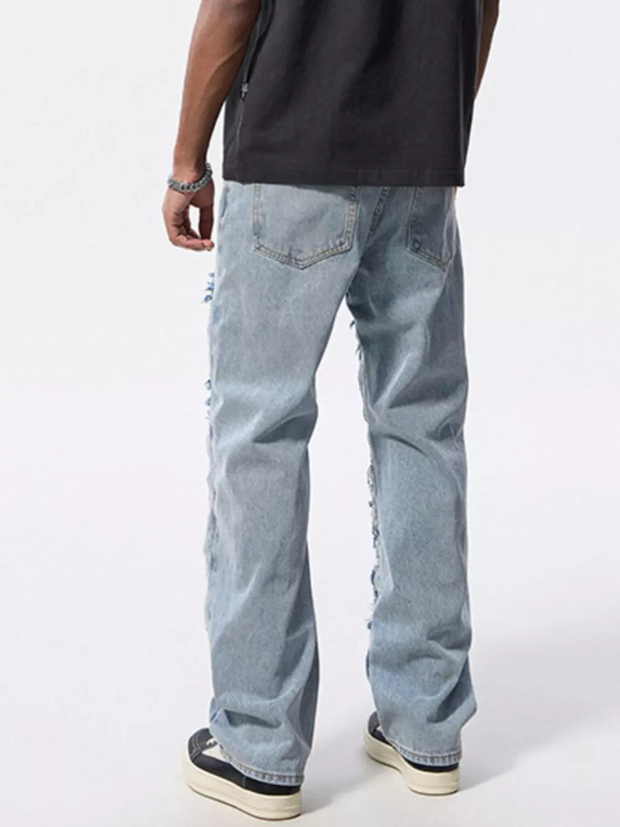 Men's light wash distressed patchwork cotton jeans with a relaxed fit.