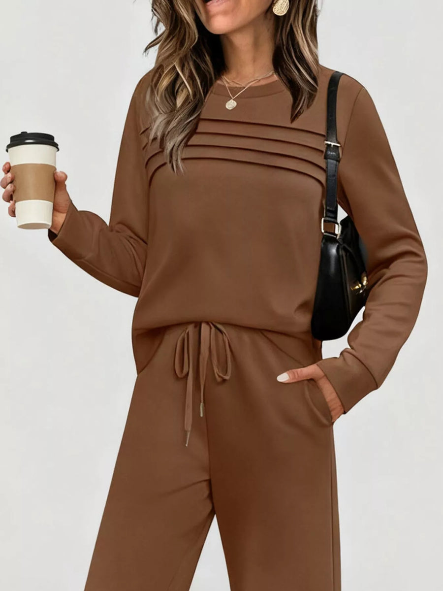 Brown long-sleeve top and drawstring pants set with pleated detail on chest.