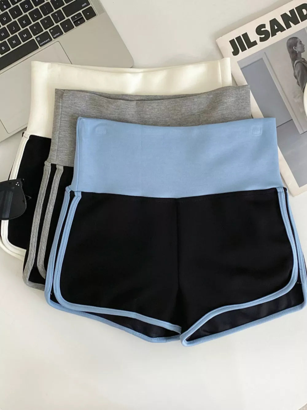 Black athletic shorts with light blue contrast trim and waistband.