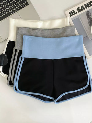 Black athletic shorts with light blue contrast trim and waistband.