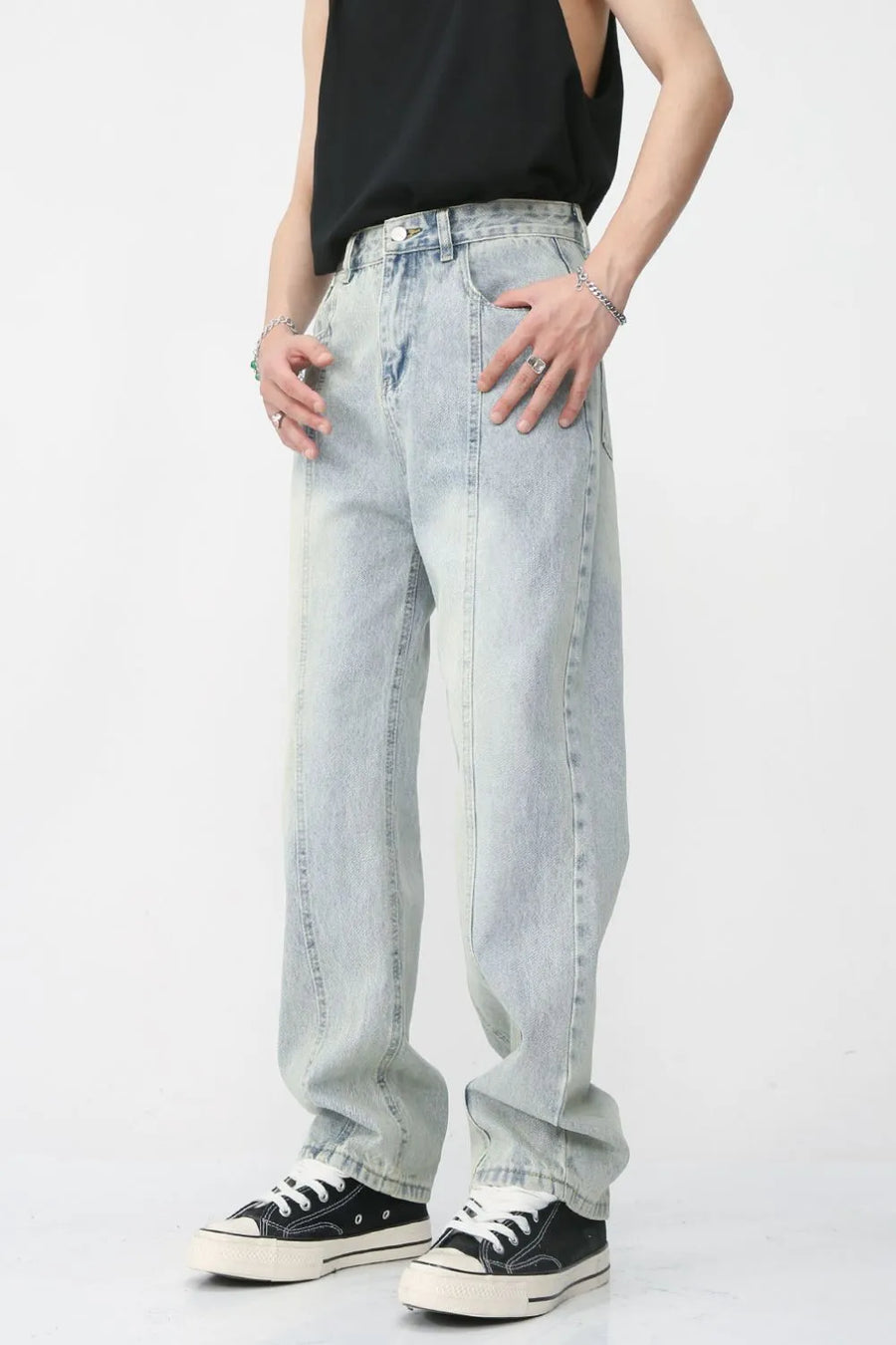 Light wash denim jeans with vertical seam detail and relaxed fit.
