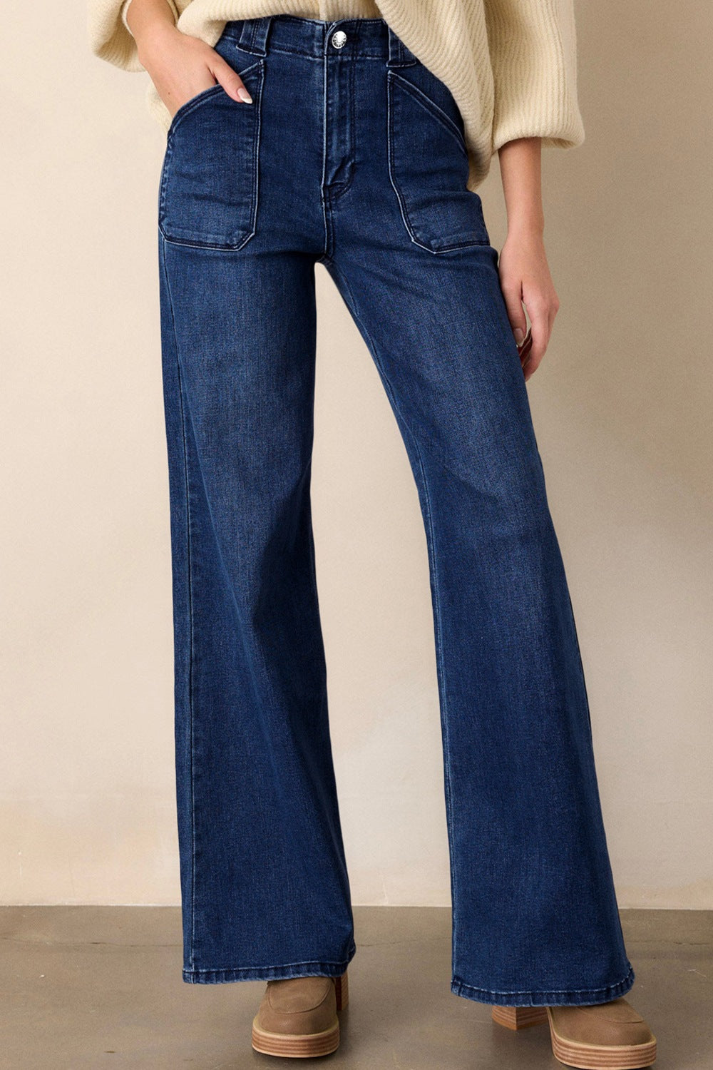 Mid-rise dark wash denim jeans with straight leg and patch pockets.