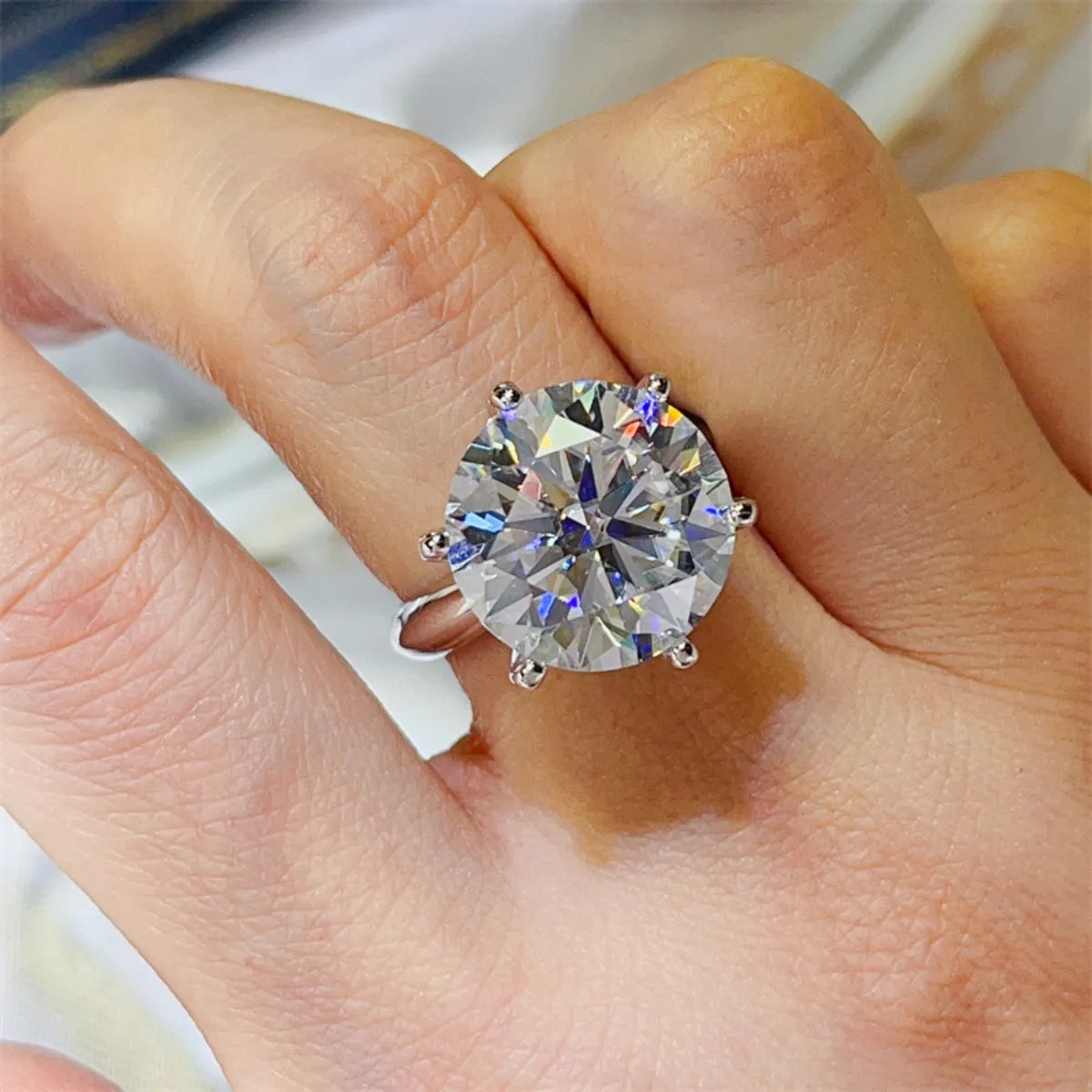Solitaire engagement ring with large round-cut diamond on a 925 silver band.