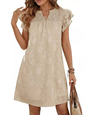 Apricot floral embossed mini dress with smocked bodice and ruffled sleeves.