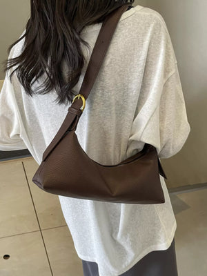 Brown minimalist PU leather crossbody bag with adjustable strap and gold buckle detail.