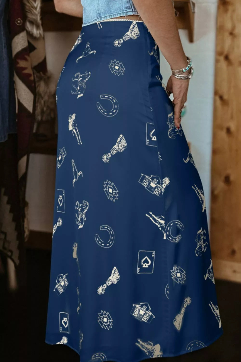 Blue satin maxi skirt with western print, featuring cowboys, horseshoes, and playing cards.