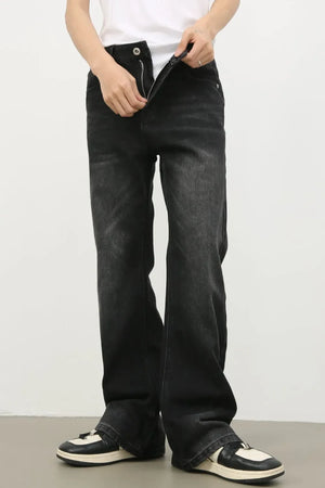 Dark wash denim trousers with exaggerated flare, styled with a white tank top and sneakers.