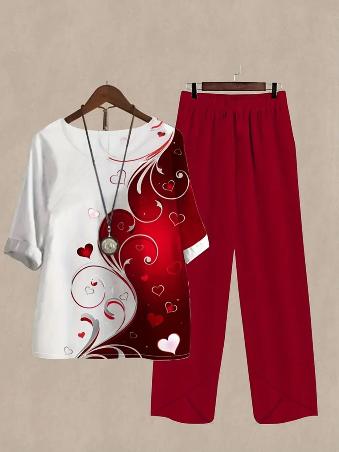 Red and white half sleeve top with heart print and matching red pants.