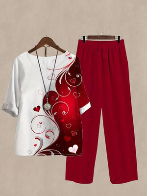 Red and white half sleeve top with heart print and matching red pants.