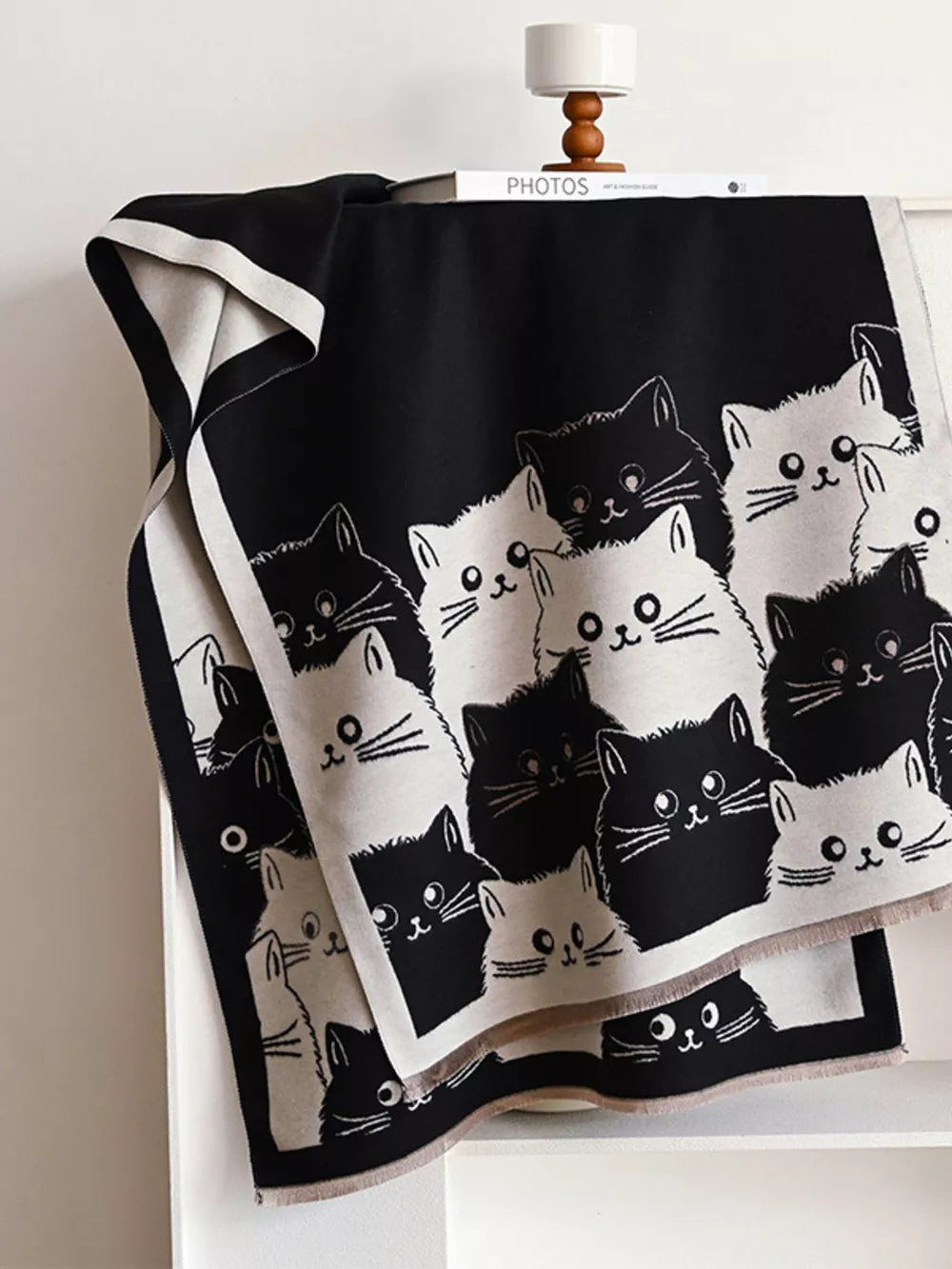 Charming reversible scarf with a black and white cat pattern, perfect for cat lovers.