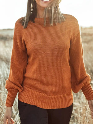 Caramel acrylic blend drop shoulder sweater with bow detail and ribbed cuffs.