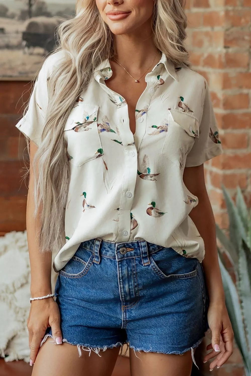 cream button-up shirt with animal-print and collared
