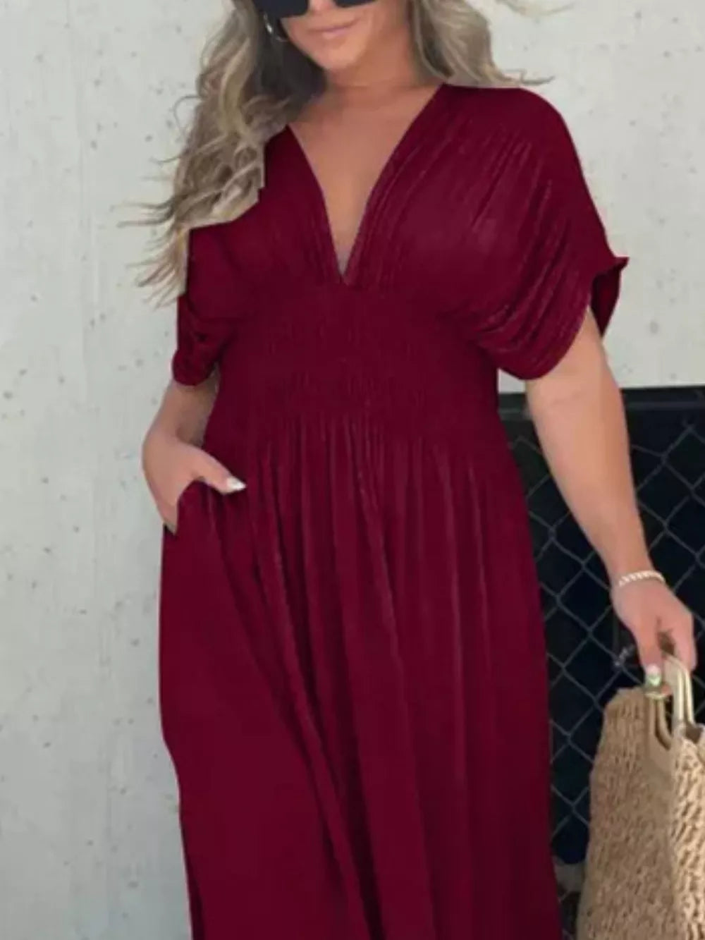 Burgundy V-neck maxi dress with smocked waist and dolman sleeves, featuring pockets.
