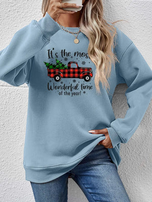 Misty Blue sweatshirt with a graphic print of a red plaid truck carrying Christmas trees and text.