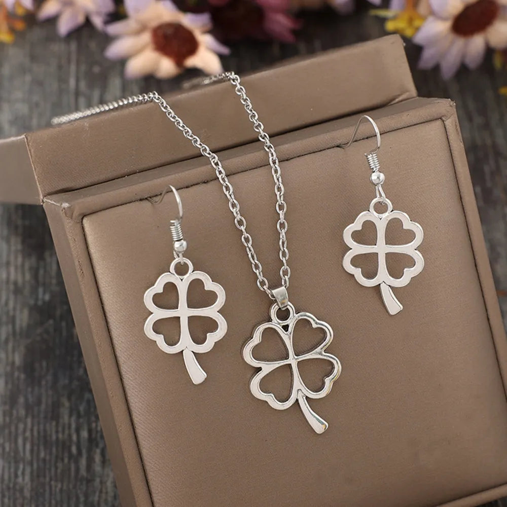 Silver four-leaf clover pendant and earring set made of alloy.