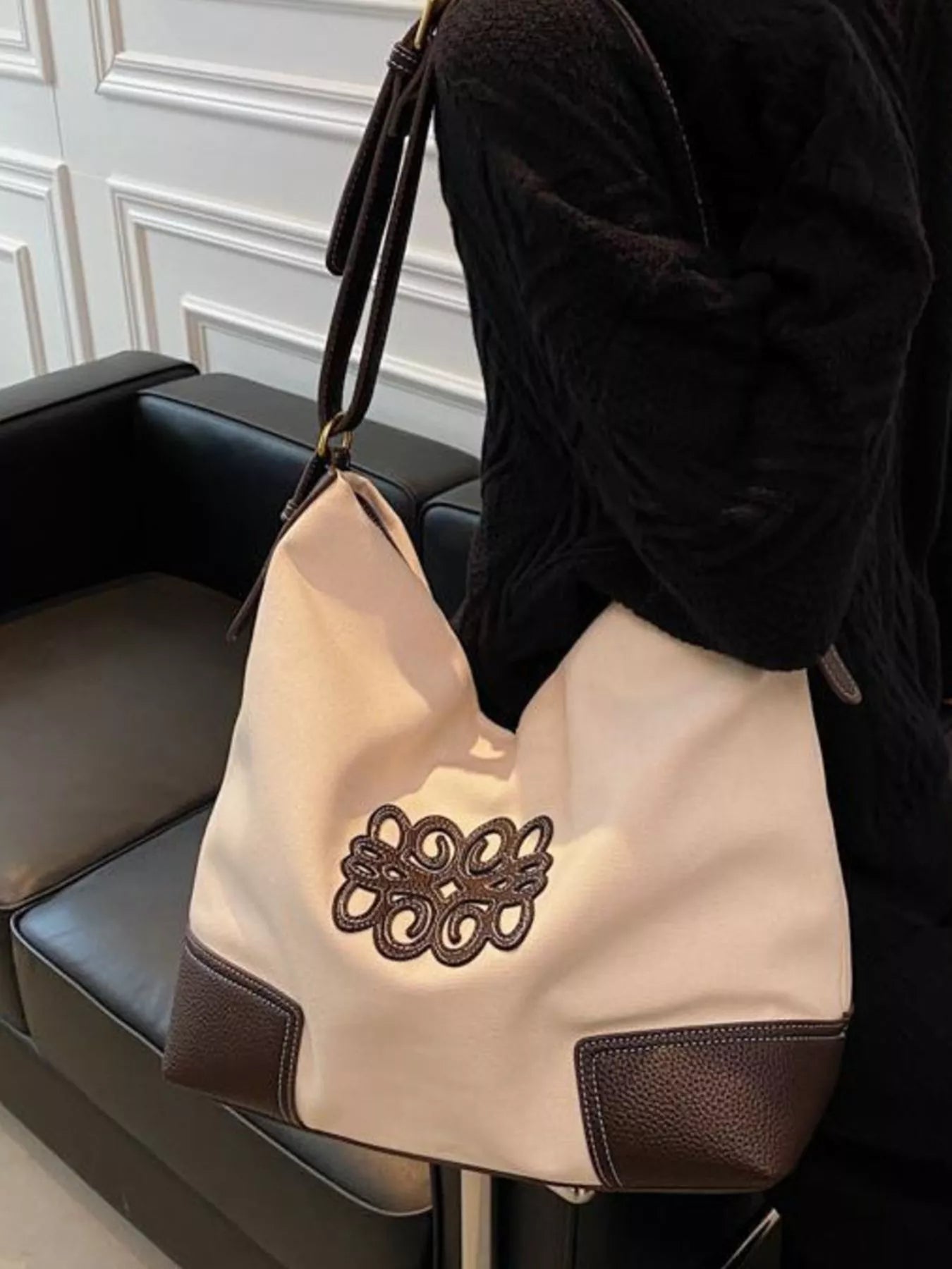 Medium canvas tote bag in white with brown leather trim and embroidered logo detail.