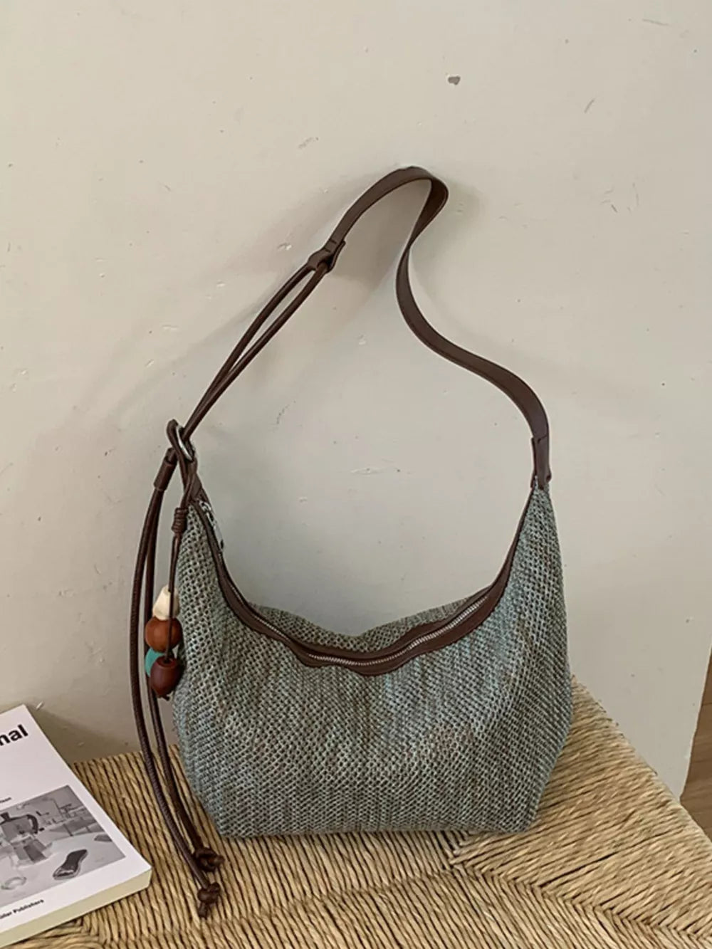 handbag in muted blue-gray with adjustable straps and not applicable