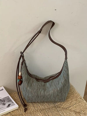handbag in muted blue-gray with adjustable straps and not applicable