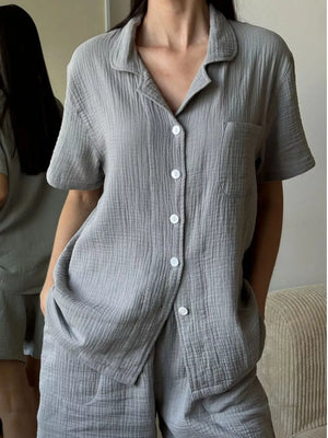 Gray cotton button-up pajama set with collared short-sleeve shirt and shorts.