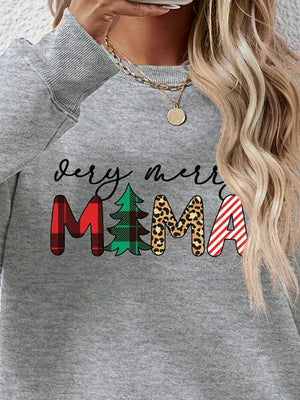 Grey long sleeve sweater with "very merry MAMA" graphic in plaid, tree, leopard, and stripe patterns.