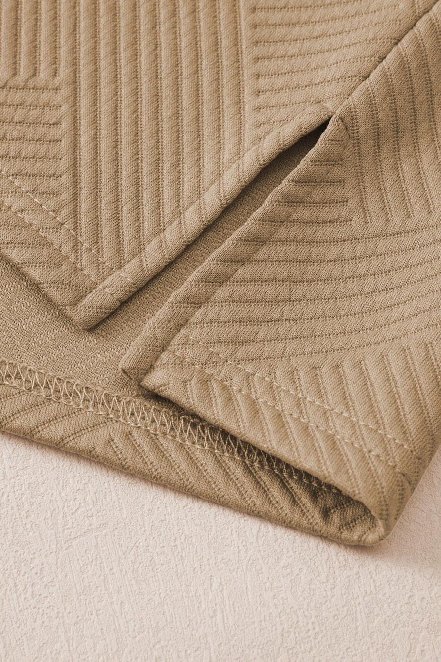 Tan textured polo set culottes with wide legs and subtle chevron pattern detail.