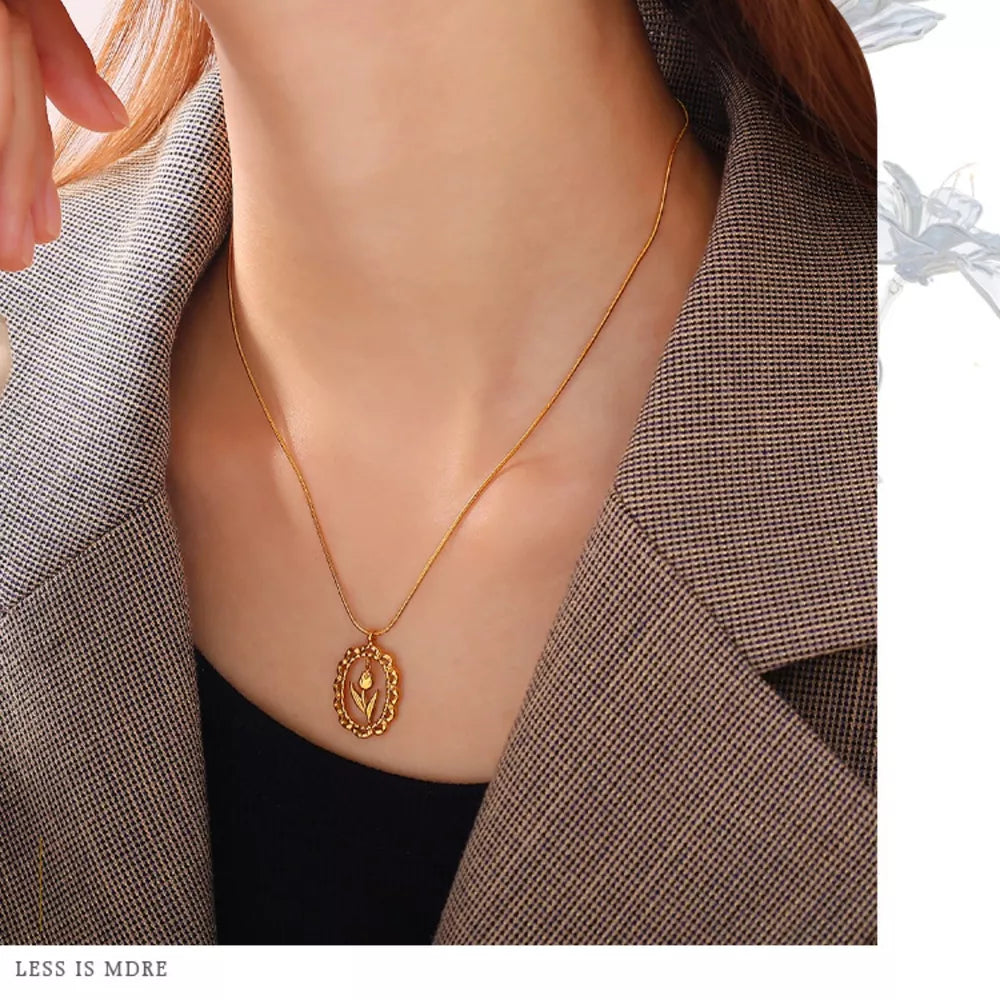 White necklace featuring pendant and floral