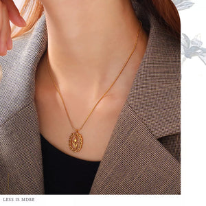 White necklace featuring pendant and floral