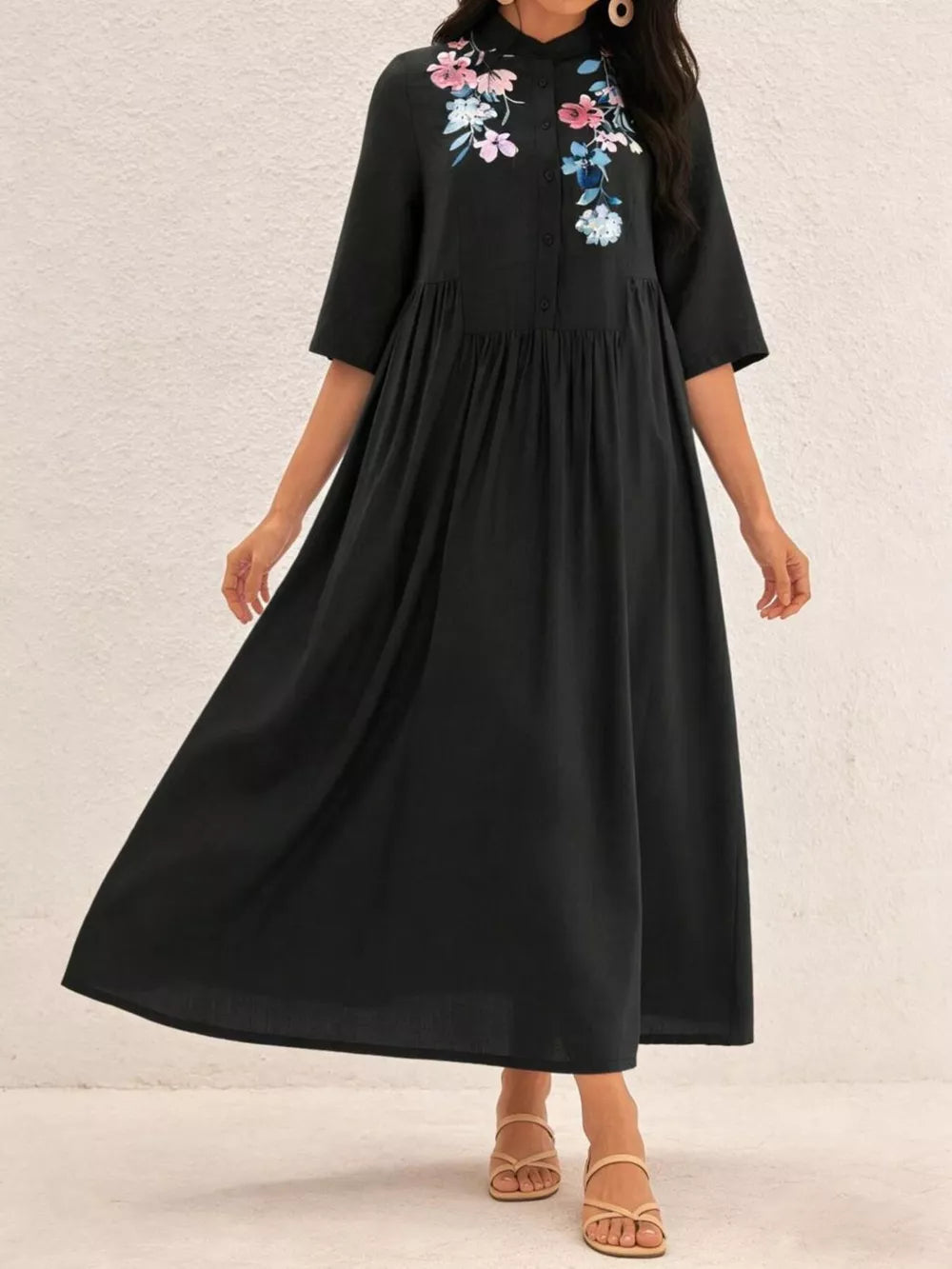 Black midi dress with embroidered floral detail and stand collar.