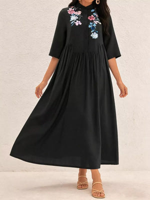 Black midi dress with embroidered floral detail and stand collar.