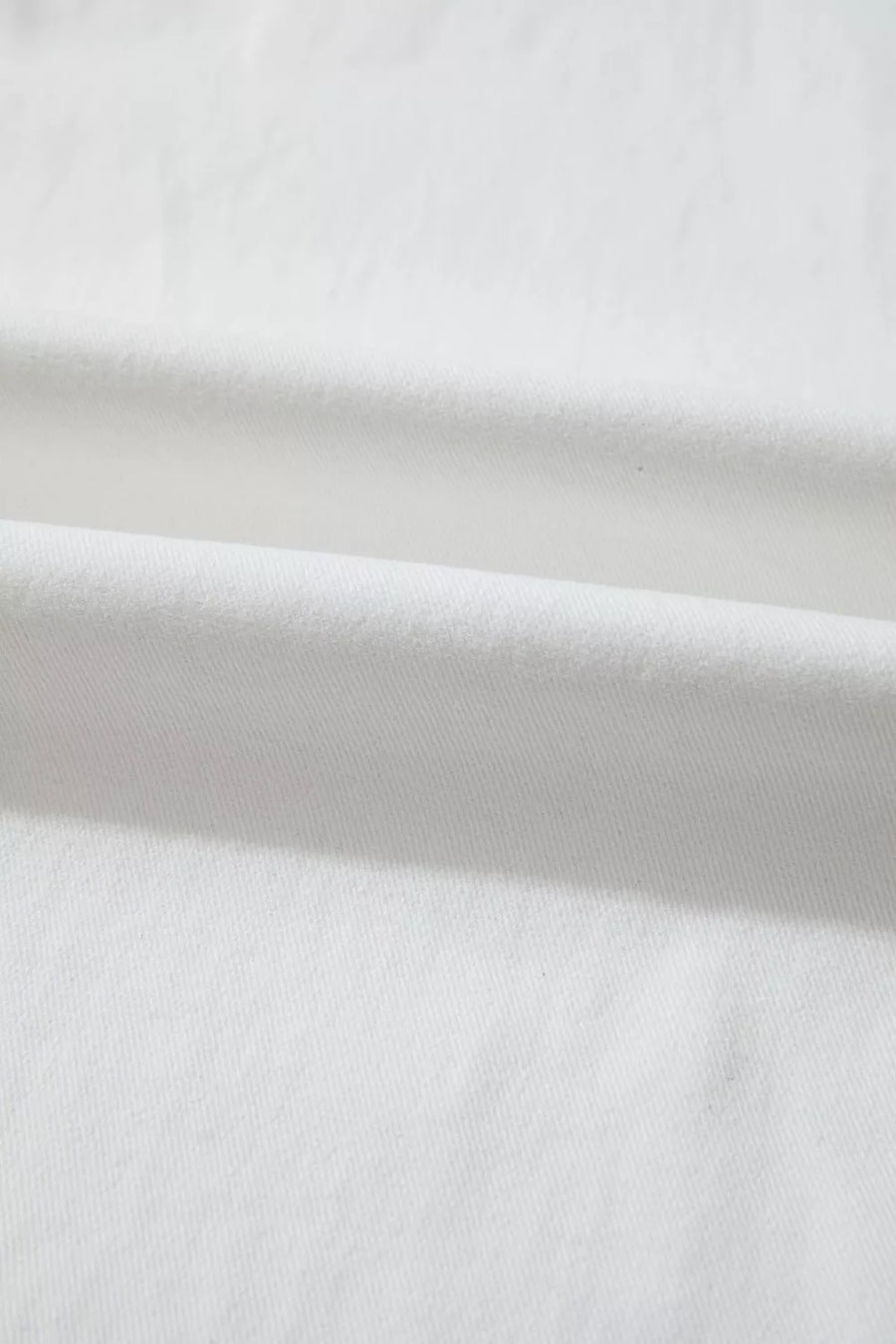 White denim casual wide-leg jeans showing fabric texture