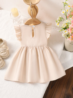 Off-white cotton baby dress with ruffle sleeves and flower appliqué detail.