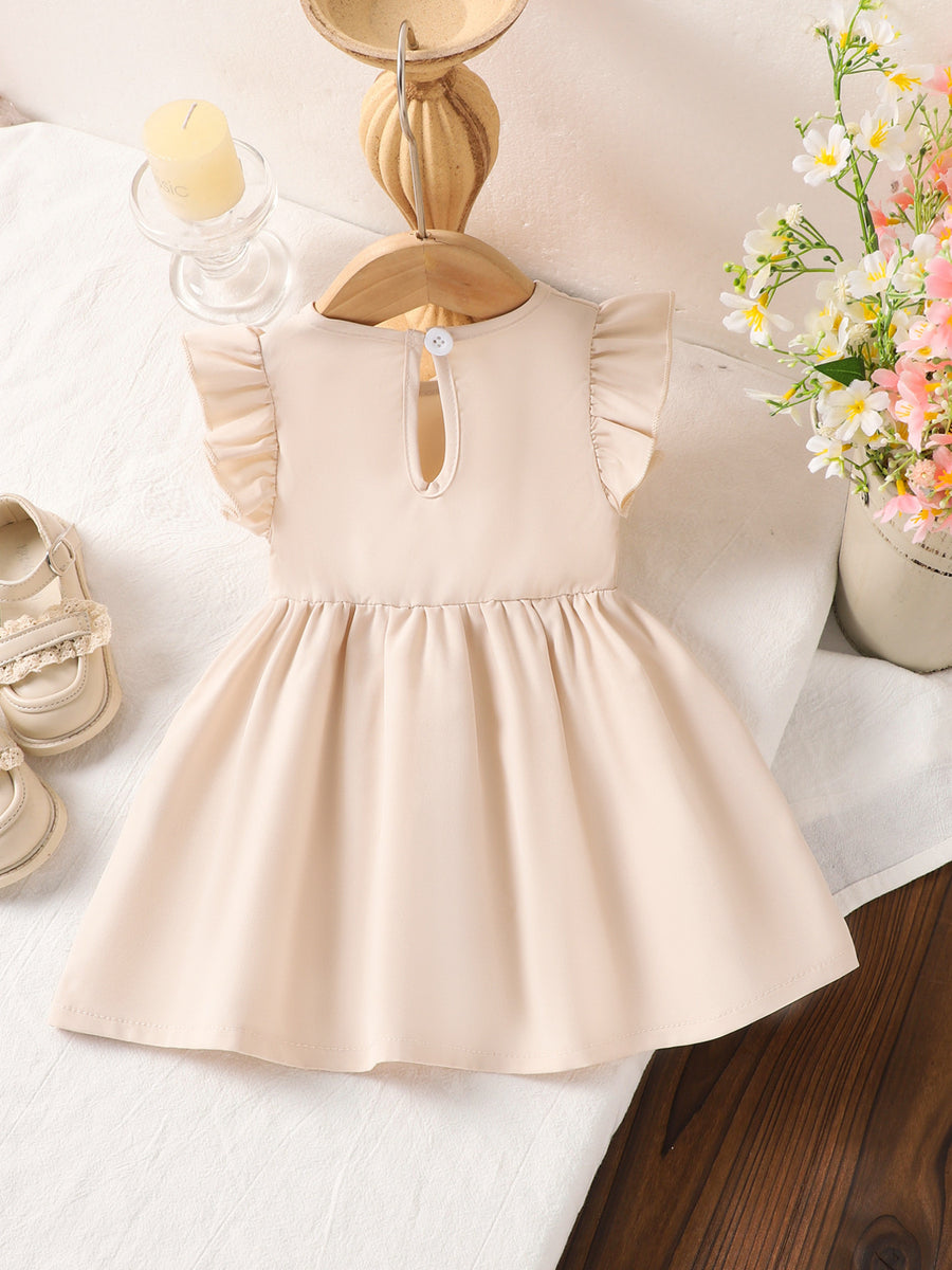 Off-white cotton baby dress with ruffle sleeves and flower appliqué detail.