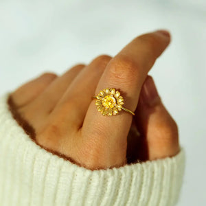 Gold sunflower ring with yellow gemstone center and detailed petals.