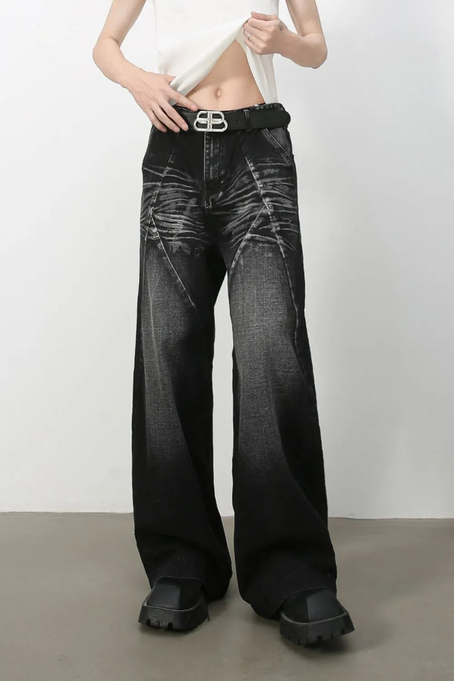 Dark wash wide leg jeans with sculpted detailing and a faded effect.