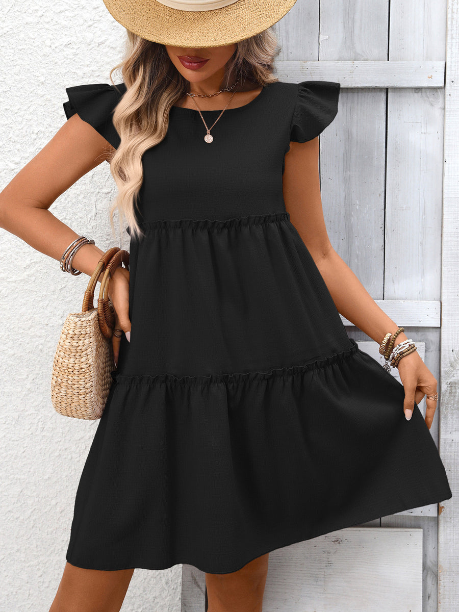Black ruffled cap sleeve mini dress with tiered skirt and round neckline.