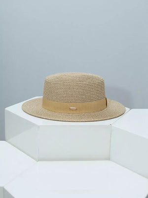 Timeless straw boater hat in tan with elegant tan band and metal detail.