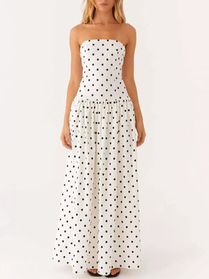White polka dot strapless maxi dress with a tiered skirt.
