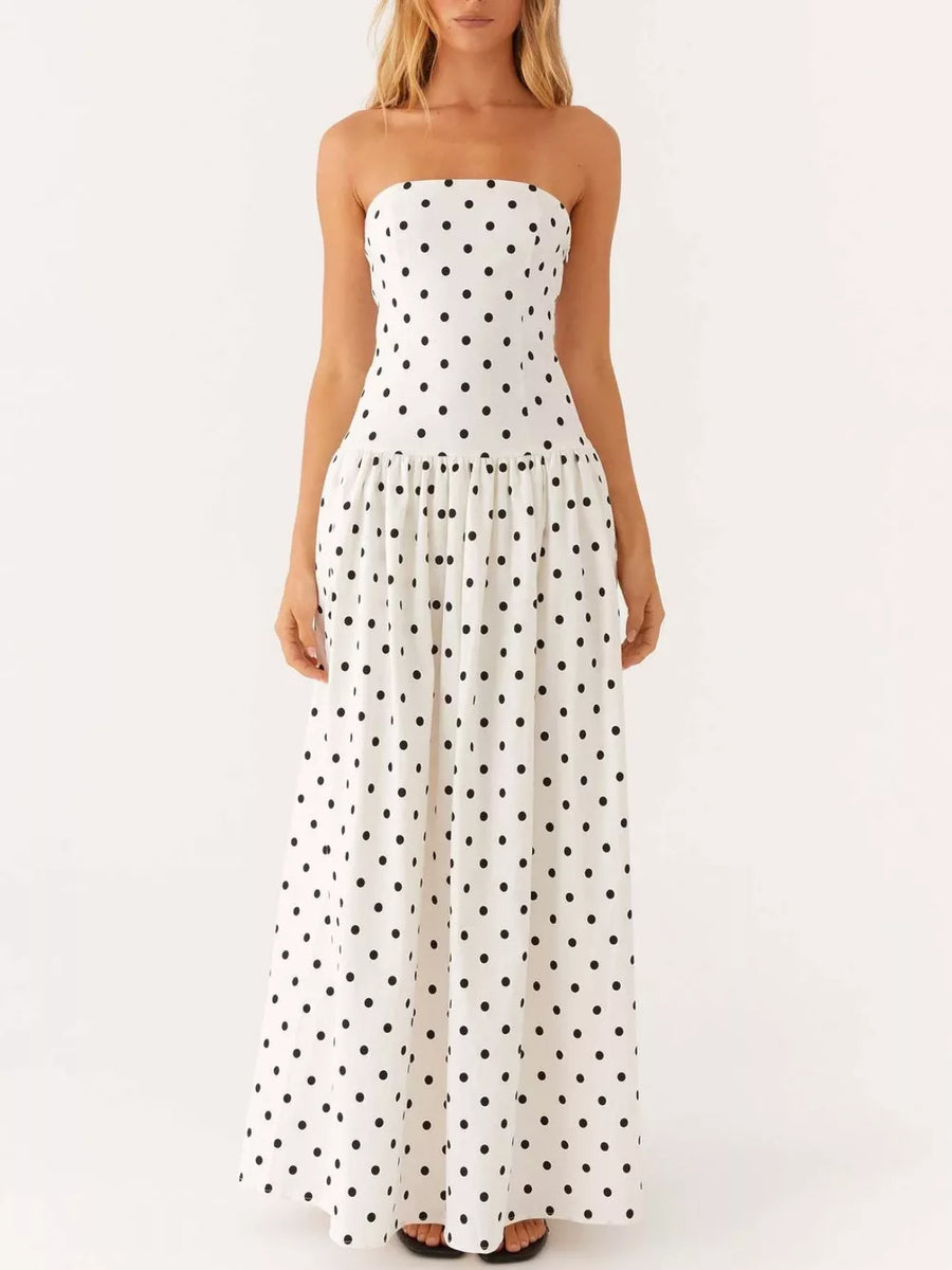 White polka dot strapless maxi dress with a tiered skirt.