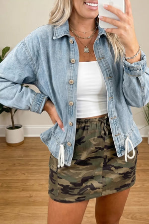 Light wash denim trucker jacket with button-down front and adjustable draw-cord hem