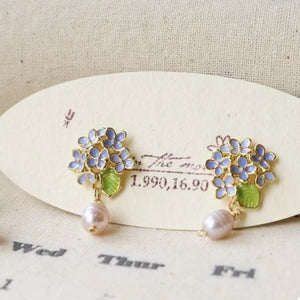 Floral pearl drop earrings in light blue with gold accents and pink pearls.