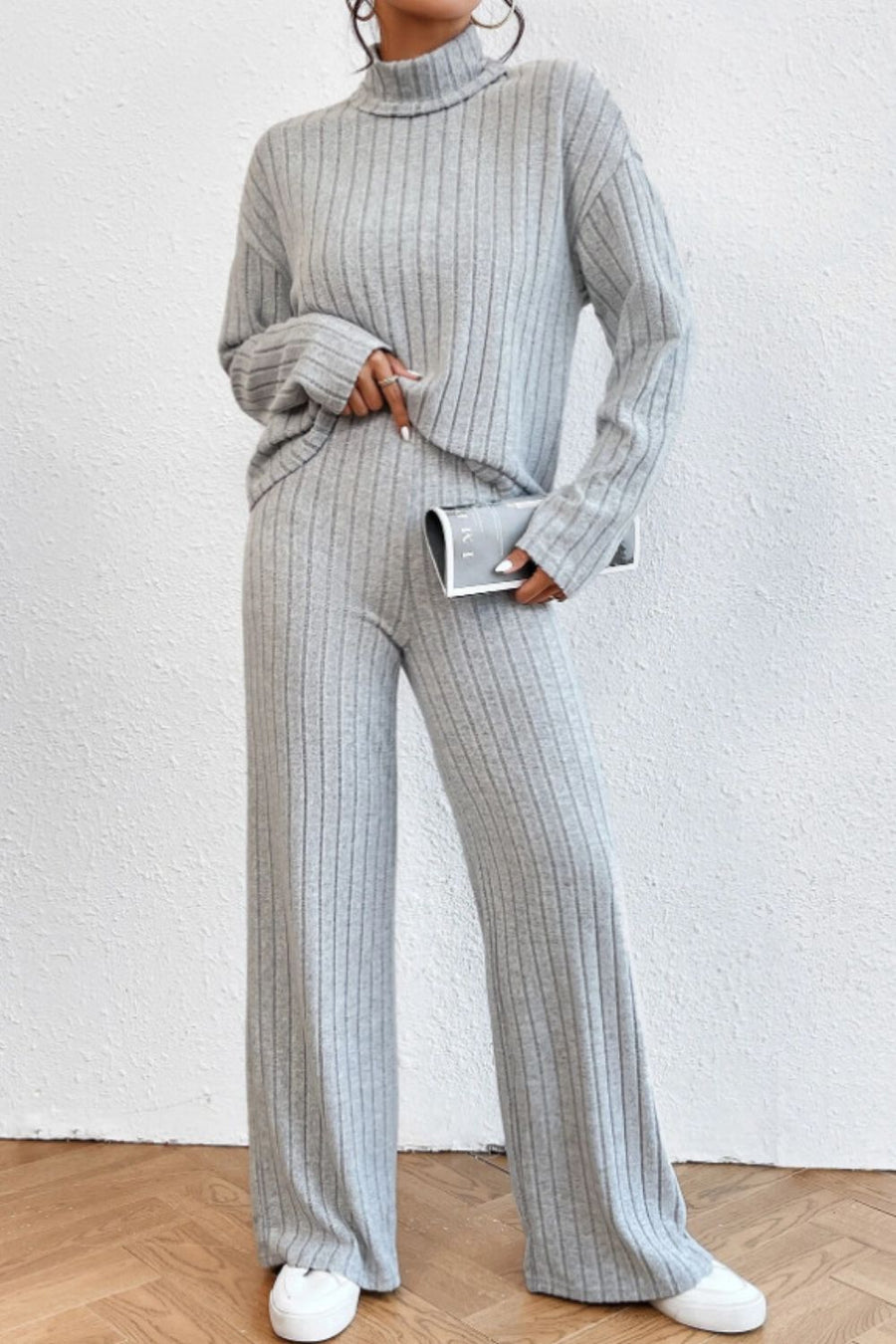 Light gray ribbed knit turtleneck loungewear set with wide leg pants.